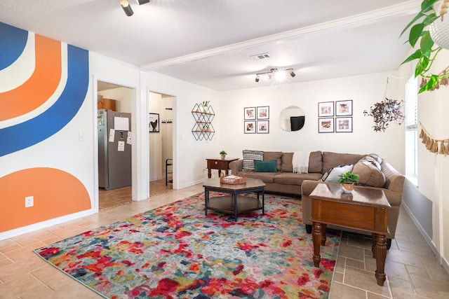 living area with baseboards and visible vents