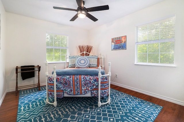 bedroom featuring a ceiling fan, baseboards, and wood finished floors