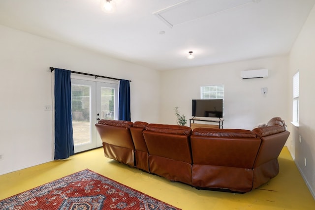 living room featuring baseboards, concrete flooring, french doors, and a wall mounted AC