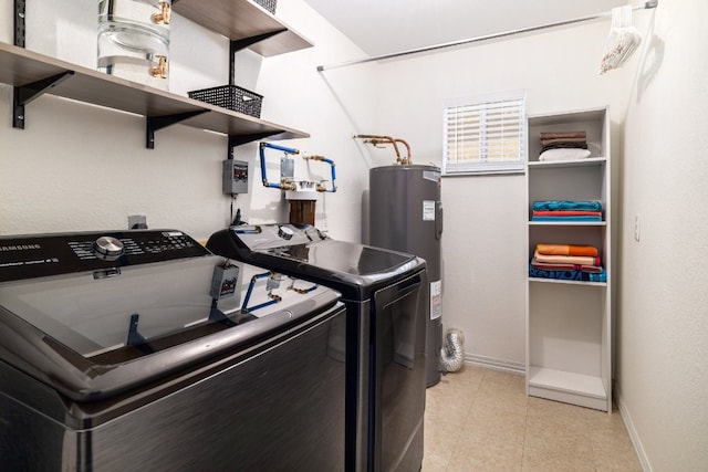 clothes washing area featuring laundry area, light tile patterned floors, baseboards, washer and clothes dryer, and water heater