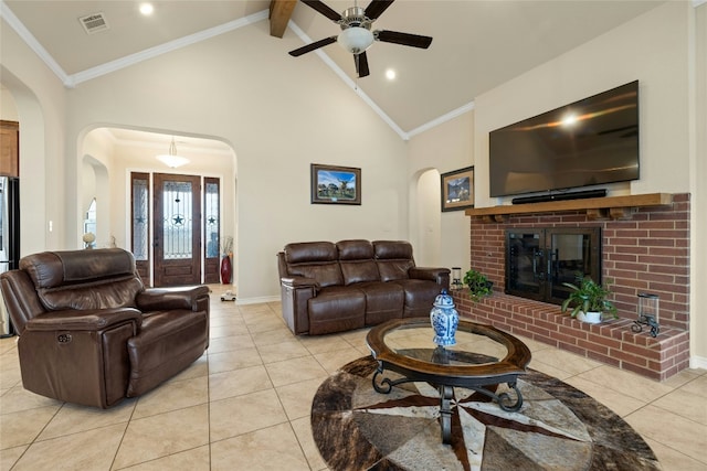 living room featuring a fireplace, arched walkways, and ornamental molding