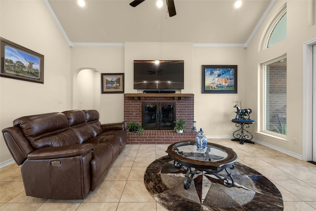 living room featuring a brick fireplace, crown molding, baseboards, and light tile patterned floors