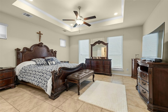 bedroom featuring ornamental molding, a raised ceiling, and visible vents