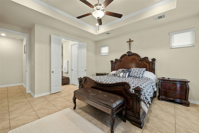 bedroom featuring baseboards, crown molding, visible vents, and a tray ceiling