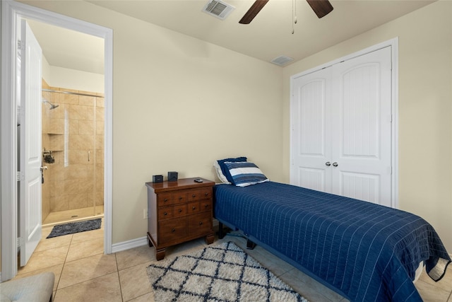 bedroom with a closet, visible vents, baseboards, and light tile patterned flooring