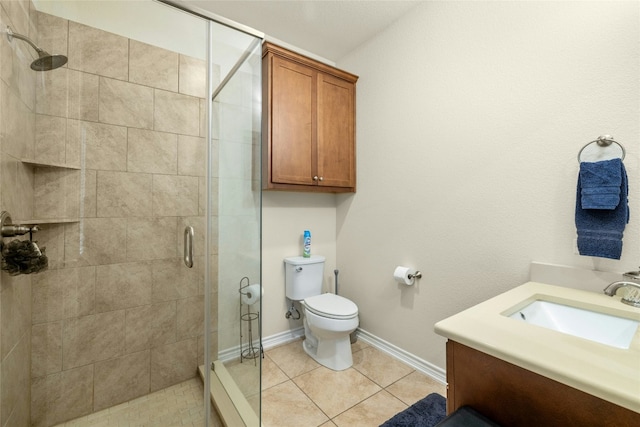 bathroom with baseboards, toilet, tile patterned flooring, vanity, and a shower stall