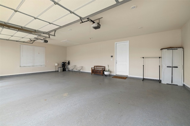 garage with a garage door opener and baseboards