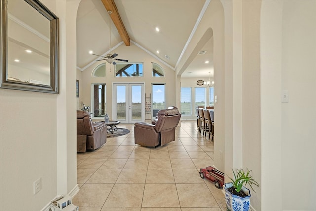 living area with high vaulted ceiling, light tile patterned flooring, french doors, beamed ceiling, and crown molding