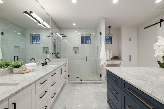 full bath featuring marble finish floor, double vanity, recessed lighting, a sink, and a shower stall