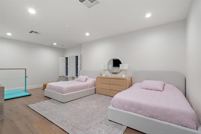 bedroom with visible vents, wood finished floors, and recessed lighting