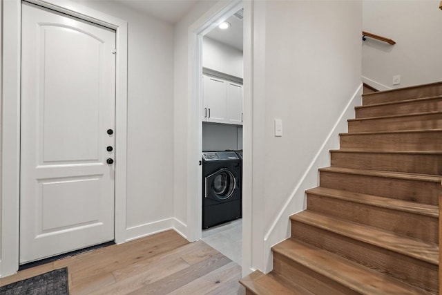 foyer with stairs and light wood finished floors