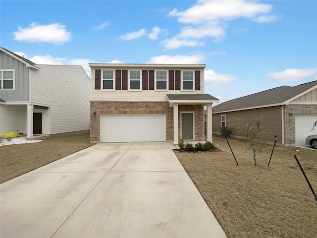 view of front facade featuring an attached garage, concrete driveway, and brick siding