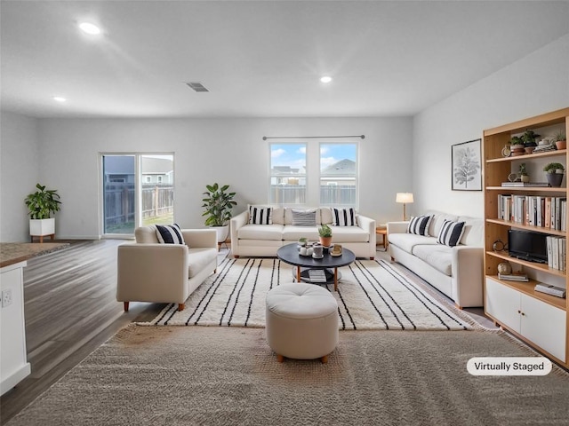 living area featuring wood finished floors, visible vents, and recessed lighting