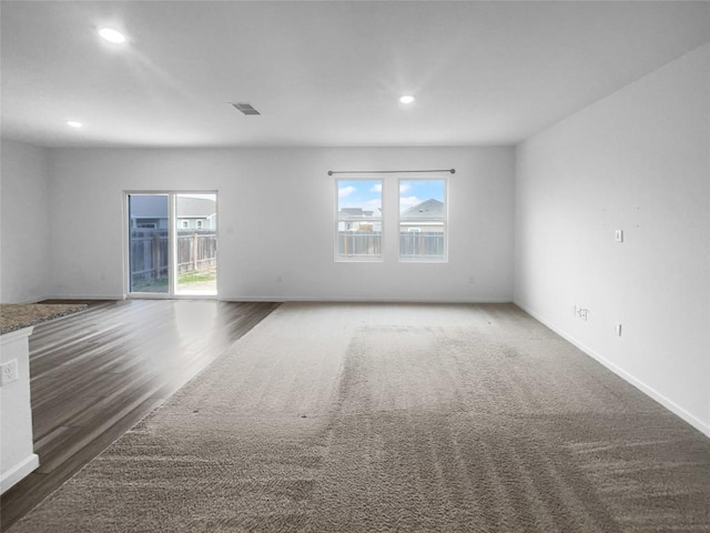 unfurnished room with visible vents, plenty of natural light, and baseboards