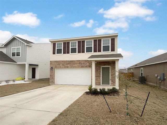 128 Gauntlet Dr, Jarrell, TX 76537 - view of front of home with brick siding, an attached garage, and concrete driveway