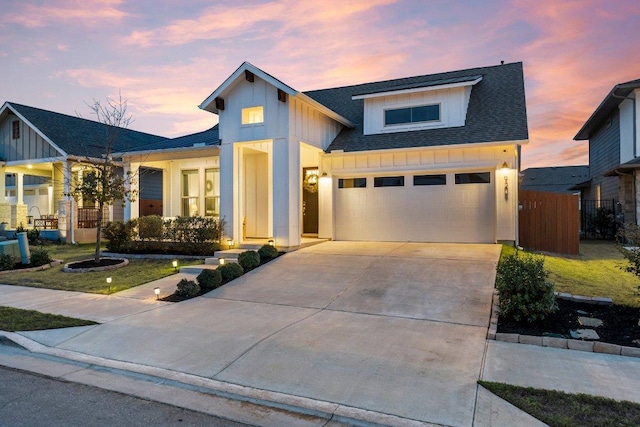 modern farmhouse style home with roof with shingles, board and batten siding, fence, a garage, and driveway