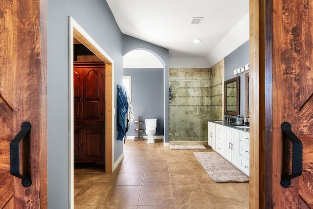 full bathroom featuring visible vents, a shower stall, vanity, tile patterned flooring, and baseboards