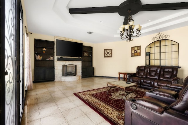 living room with built in shelves, an inviting chandelier, a stone fireplace, beamed ceiling, and baseboards