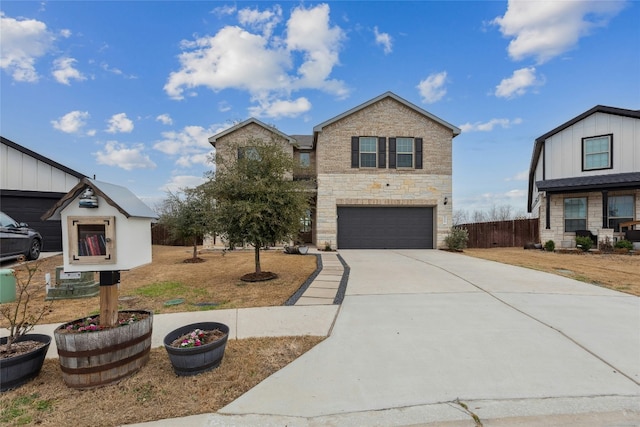 traditional home featuring driveway, stone siding, an attached garage, and fence