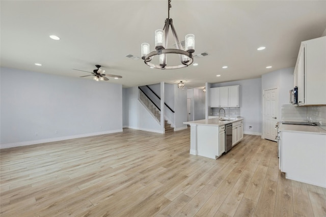 kitchen featuring tasteful backsplash, visible vents, stainless steel appliances, light countertops, and light wood-type flooring