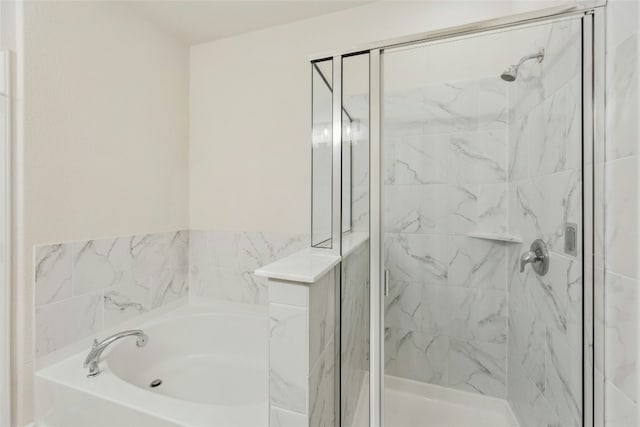 full bath featuring a garden tub and a shower stall