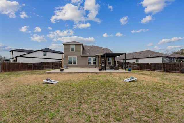 back of property featuring a yard, a fenced backyard, and a patio