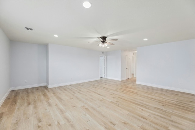 unfurnished room with light wood finished floors, baseboards, visible vents, and a ceiling fan