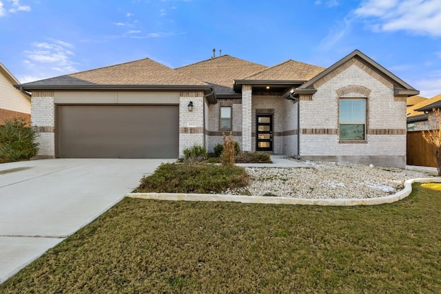 view of front of house with a garage, brick siding, a shingled roof, concrete driveway, and a front lawn