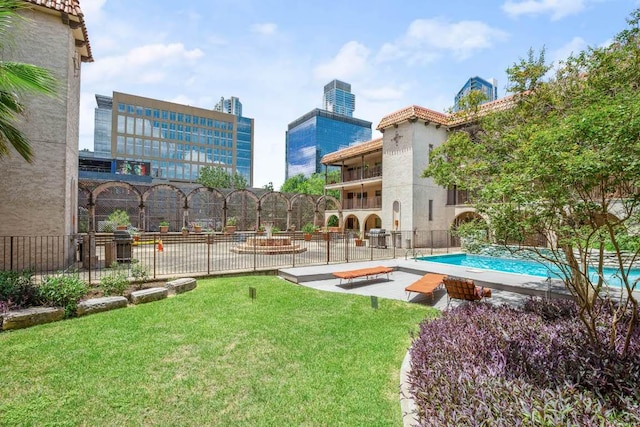 exterior space with a yard, fence, and a fenced in pool