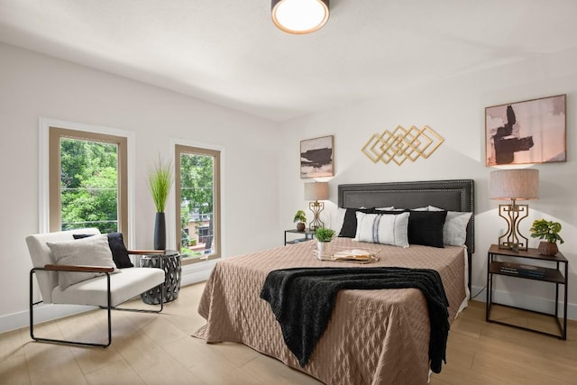 bedroom with baseboards and light wood-style floors