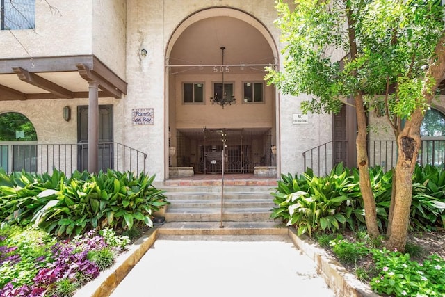 doorway to property featuring stucco siding