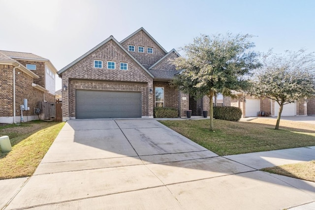 view of front of house featuring a garage, driveway, a front lawn, and brick siding