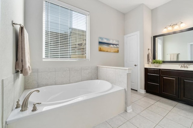 bathroom with a garden tub, vanity, tile patterned flooring, and a wealth of natural light