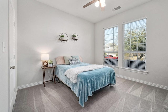 bedroom featuring ceiling fan, carpet floors, visible vents, and baseboards