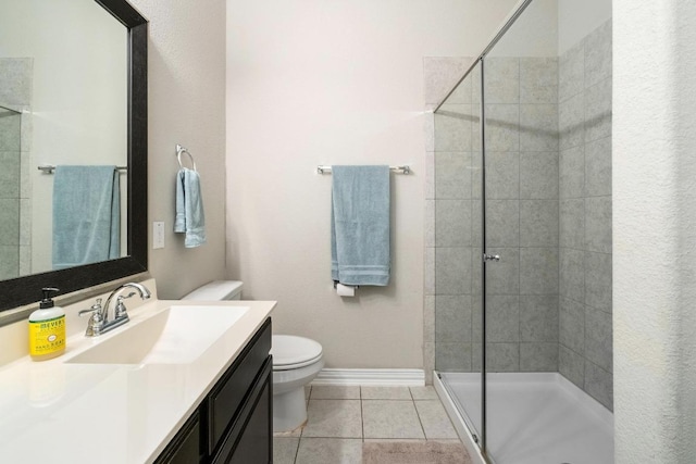 full bath featuring tile patterned flooring, toilet, vanity, baseboards, and a stall shower