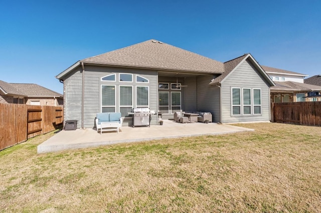 rear view of house featuring a patio area, a fenced backyard, and an outdoor hangout area