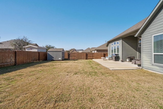 view of yard with a patio area, a fenced backyard, a storage shed, and an outdoor structure