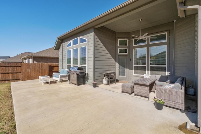 view of patio / terrace featuring a ceiling fan, a grill, fence, and an outdoor living space