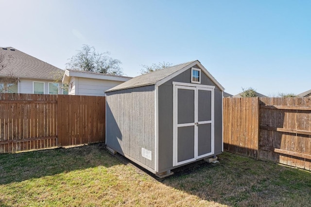 view of shed with a fenced backyard