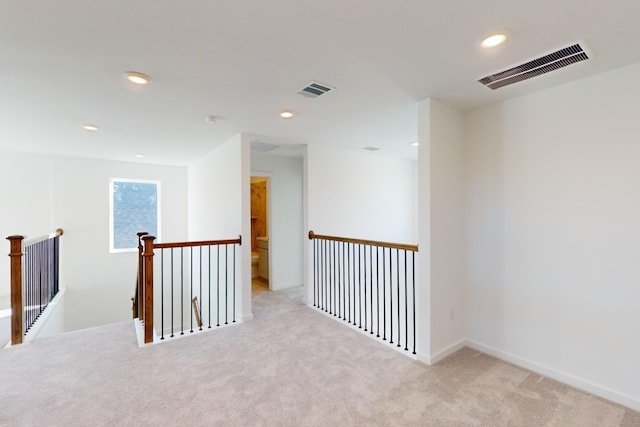 corridor with recessed lighting, carpet, visible vents, and an upstairs landing