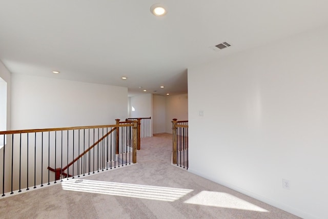 hall with carpet, visible vents, an upstairs landing, and recessed lighting