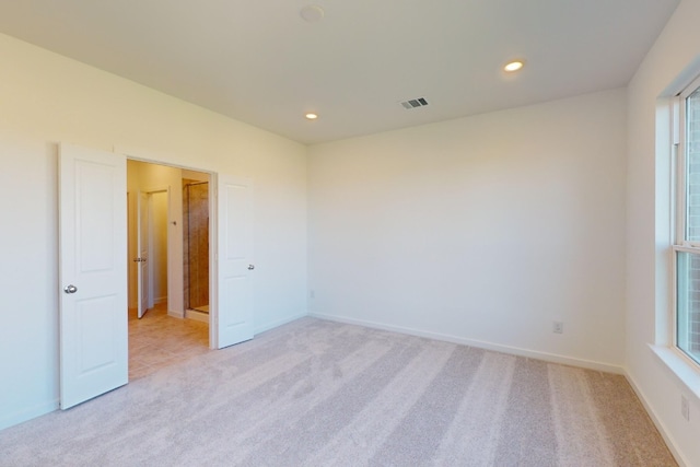 unfurnished room with recessed lighting, visible vents, light carpet, and baseboards