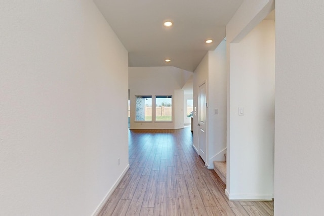 hallway featuring light wood-style floors, recessed lighting, and baseboards