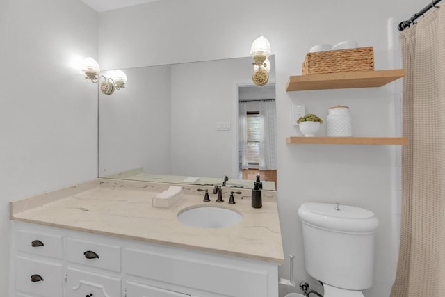 bathroom with toilet and vanity