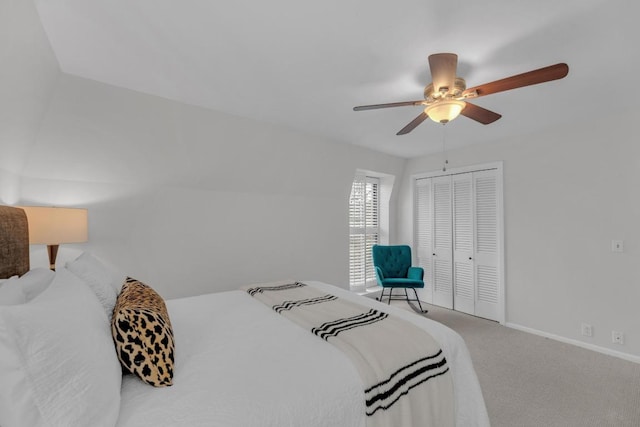 carpeted bedroom with ceiling fan, baseboards, and a closet