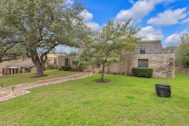 view of front of property featuring a front yard and brick siding