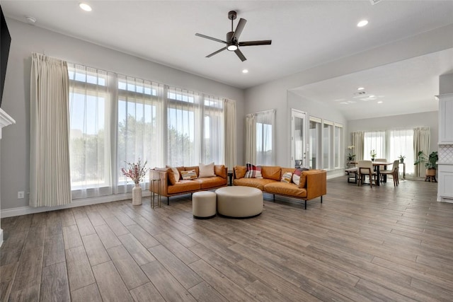 living area featuring ceiling fan, wood finished floors, and recessed lighting