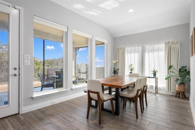 dining space featuring dark wood finished floors, vaulted ceiling, baseboards, and recessed lighting