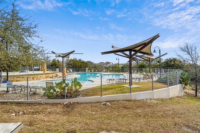 surrounding community with fence, a lawn, a swimming pool, and a patio