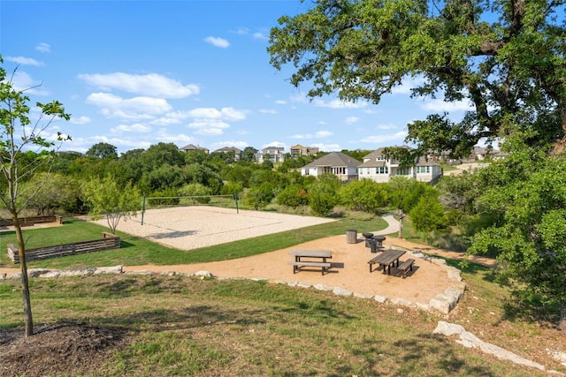 surrounding community featuring a lawn and volleyball court